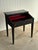 Early American slant front desk in original black paint with hand stenciled vine and grape decoration. Hinged writing...