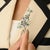 Bring timeless elegance and natural charm to your jewelry collection with this exquisite floral branch brooch. Crafted...