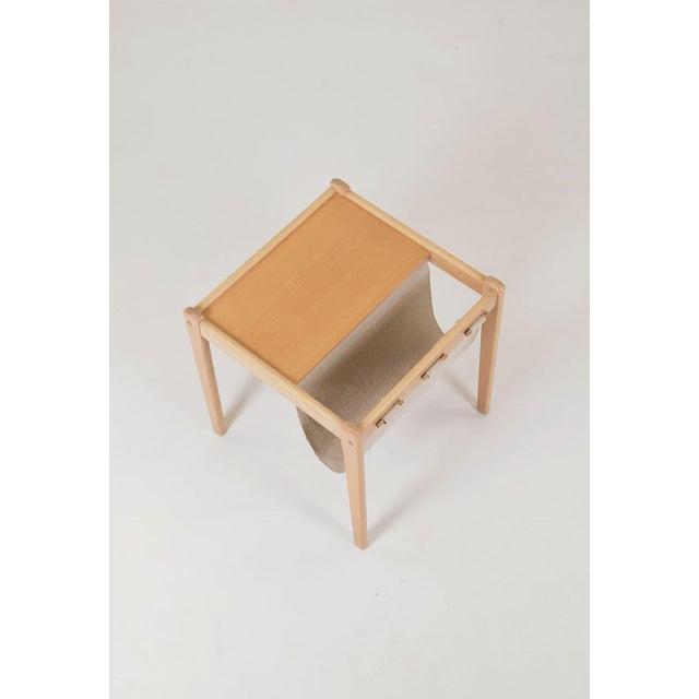 Mid-century side table with magazine holder designed by SP Jensen and manufactured by the Danish company BRDR Furbo. It is...