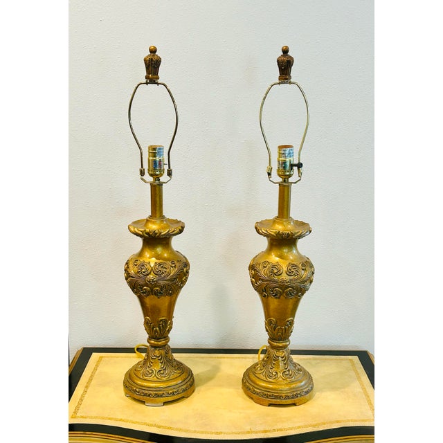 Beautiful and sophisticated pair of vintage Berman gold lamps with hints of gray and red veining and detailed scroll...