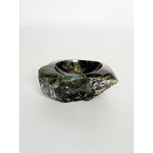An elegant bowl carved from a block of natural stone, dating from the 1950s. The upper part is carefully polished,...
