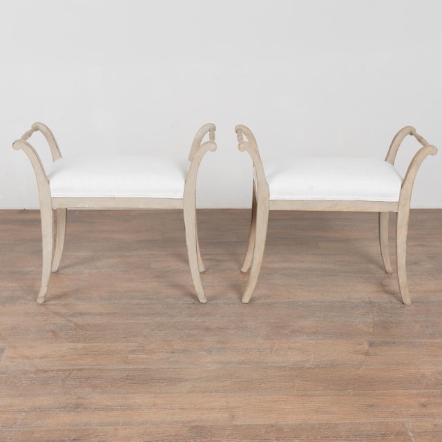 This lovely pair of Swedish stools or tabourets have gently curved arms and splayed saber legs which create an elegant...
