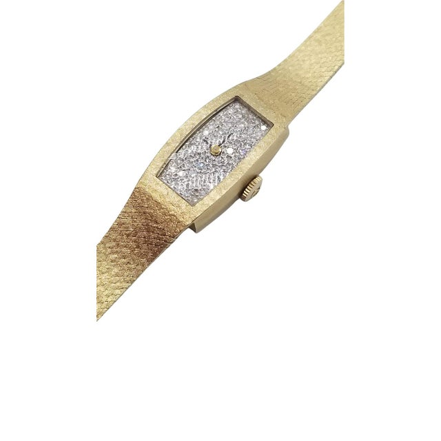 Vintage 1960 14k gold Omega women's wristwatch with a diamond-encrusted watch face containing over 20 1ct diamonds and...
