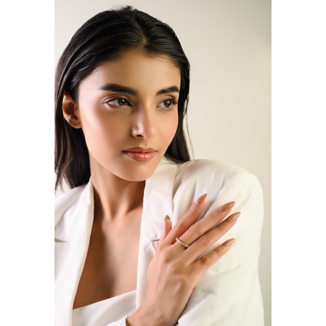 This elegant half eternity band ring features a 11 round brilliant-cut diamonds totaling 0.69 carats, beautifully set in...