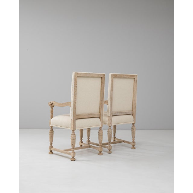 This pair of 1900s French oak armchairs exemplifies the refined craftsmanship of early 20th-century design. Each chair...