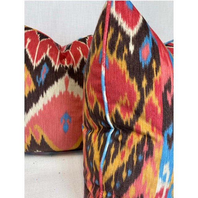 Custom pair of 22" pillows covered in an ikat printed velvet. These pillows are self welted, have tapered corners to...