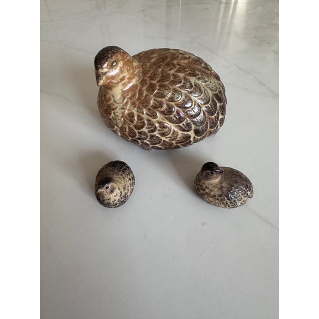 A charming mid-century modern ceramic quail family set, consisting of a mother quail and two chicks, crafted in Japan and...