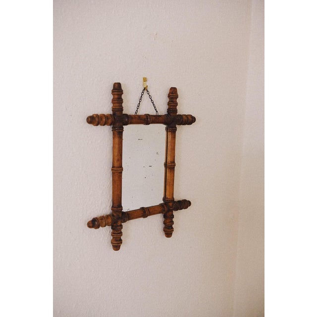 An antique petite French mirror from around 1900, hand-carved to resemble bamboo. The wood has its original finish and...