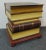 Leather faux book stack side table , top book lifts up wit storage compartment inside , mahogany trim base with ball feet