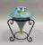 Stunning lime green and and vibrant blue crystalline porcelain vase on a black wrought iron stand. The green ground has a...