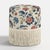 Elevate your living space with the Tambor Ottoman with Fringe in an exclusive Tree of Life printa delightful blend of...