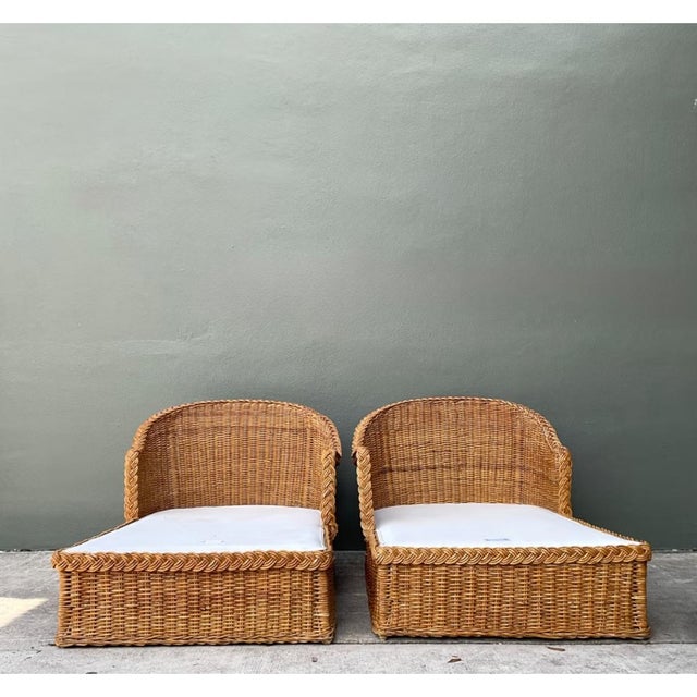 This pair of vintage Mid-Century Modern chaise lounges showcases the natural beauty of braided rattan in a relaxed, low-...