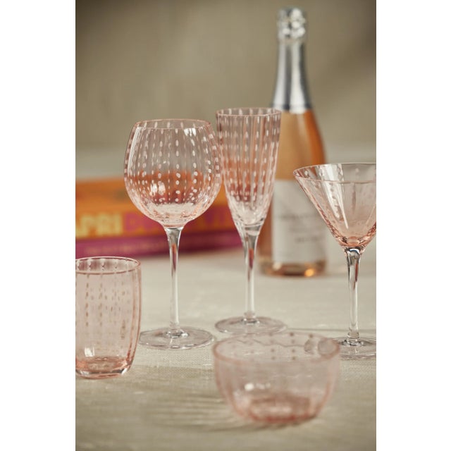 This set of martini glasses is perfect for chic festive celebrations. Made from colored glass with white color polka dot...