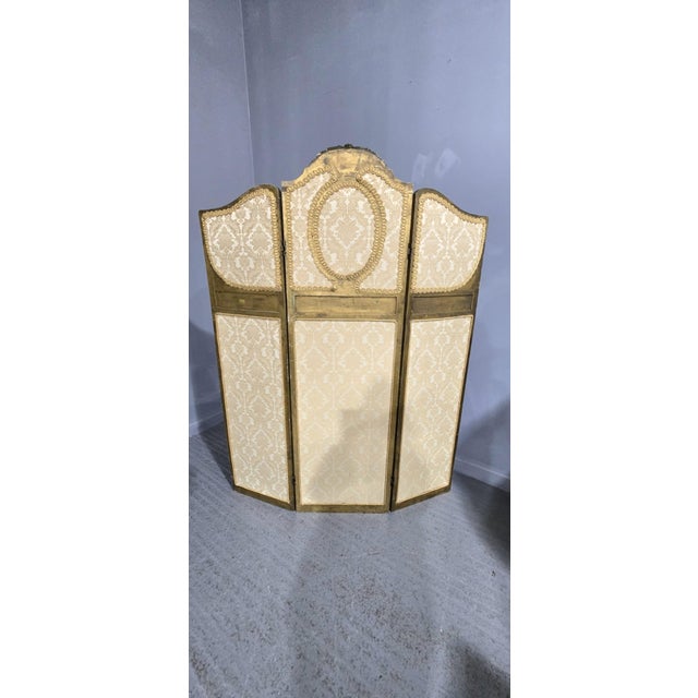 A very nice French three fold screen with damask fabric bottom and mirror backed carved gilt mouldings, in very good...