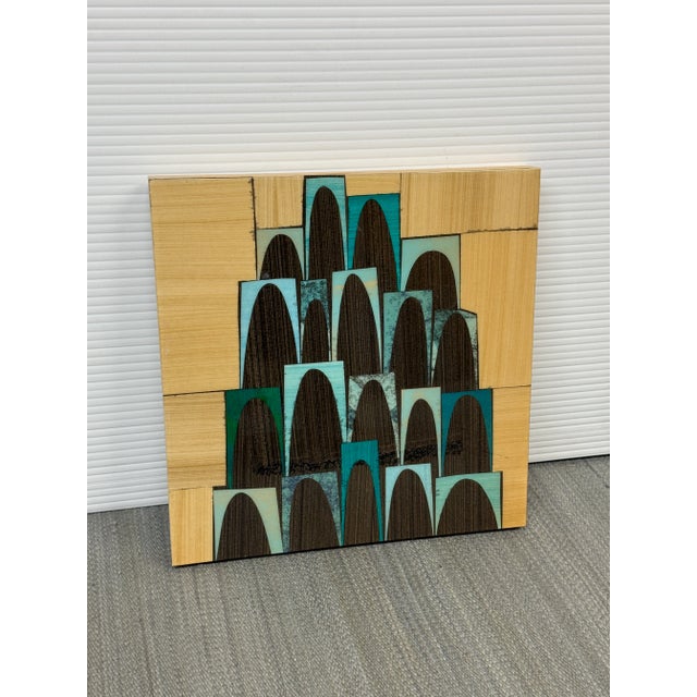 Design Plus Gallery presents a Circa 2005 Mixed-Media Collage from Artist Rex Ray (1956 - 2015). A square wood frame with...