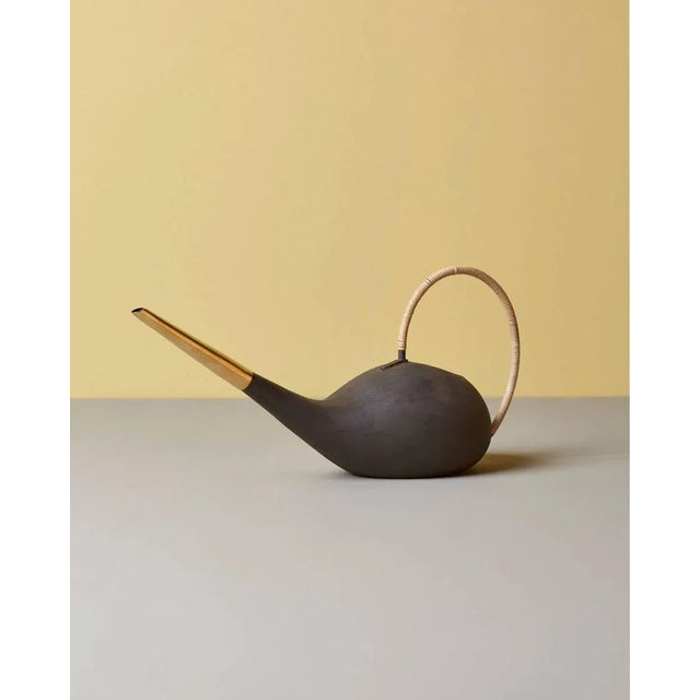 Patinated watering can #3632 by Carl Auböck in brass and cane. This piece is attributed to the mentioned designer/maker....