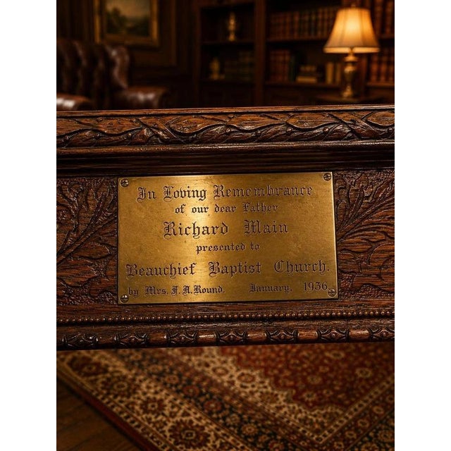 An exceptional English hand-carved solid oak refectory table, dating to 1936 and retaining its original brass presentation...