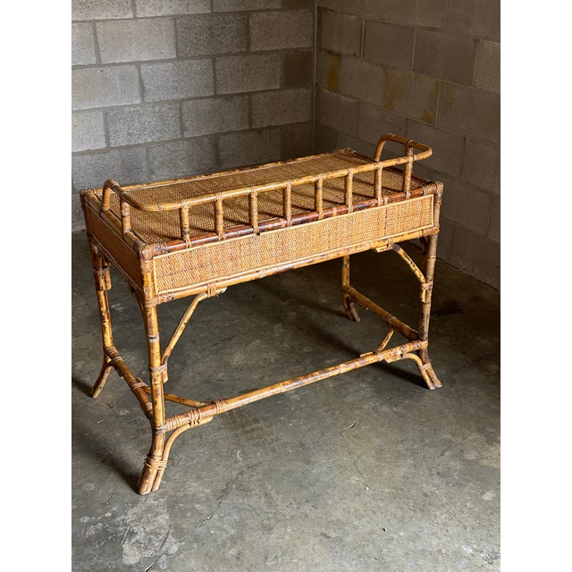 Great 1980s burnt bamboo desk with two drawers. Skelton frame in burnt bamboo with cane surface and wrapped rattan corners...