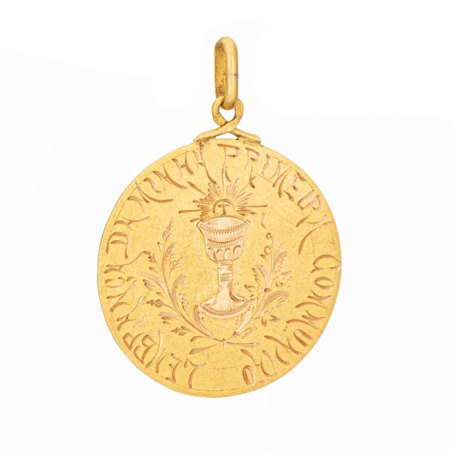 Finely detailed antique 1st communion medallion crafted in 19k yellow gold. Crafted in Portuguese 19k yellow gold, the...
