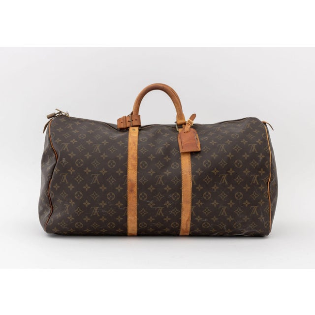 Louis Vuitton Monogram "Keepall" Travel Bag, Vechetta leather handles, fabric interior. 11.5" H x 23" W x 12" D....