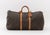 Louis Vuitton Monogram "Keepall" Travel Bag, Vechetta leather handles, fabric interior. 11.5" H x 23" W x 12" D....