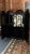A stunning late 19th century English Chinoiserie bar cabinet featuring richly detailed gilt landscape scenes over a deep...