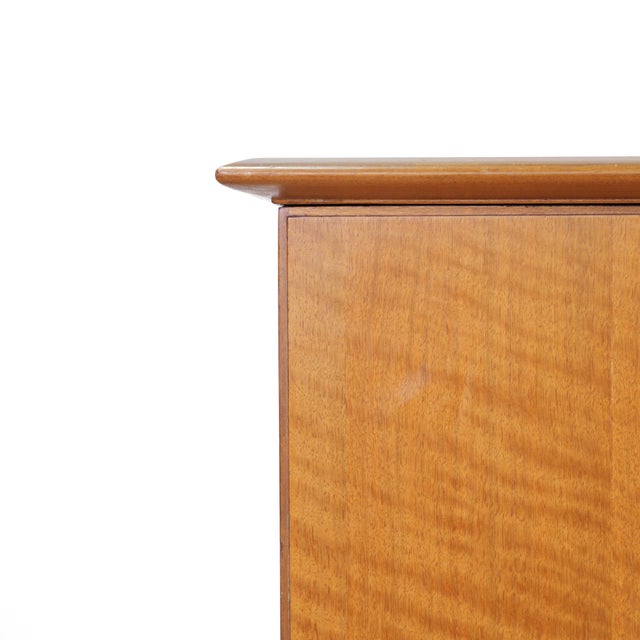 Handsome mid century modern armoire by Alfred Cox Furniture featuring beautifully figured book matched front African...
