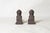 Pair of 19th-century cast iron andirons. Height 19 cm. Width 9 cm. Depth 32 cm. Signs of wear and age.