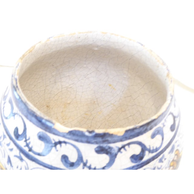 This hand painted tobacco jar has a crackle glaze and a marking on the underside.
