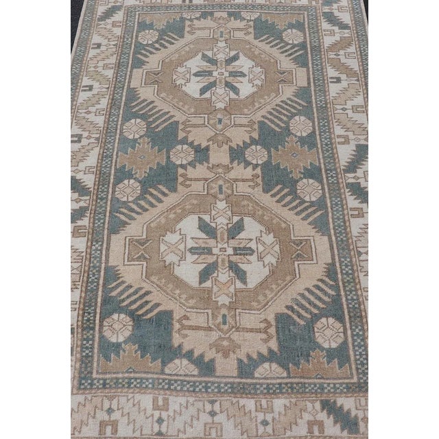 Measures: 3'10 x 6'7 This exquisite vintage Turkish Oushak rug showcases a sophisticated design that blends earthy hues...
