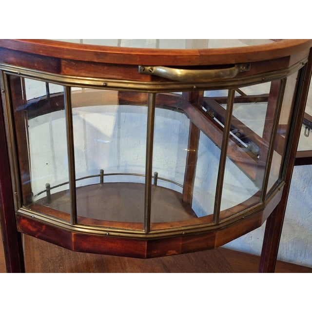 Serving trolley / bar cart in mahogany, brass and glass dating from about 1920. Beautifully designed piece with an...