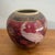 Small vintage chinoiserie ceramic vase with a white peacock and gold florals on a deep burgundy ground. Ornate shoulder...