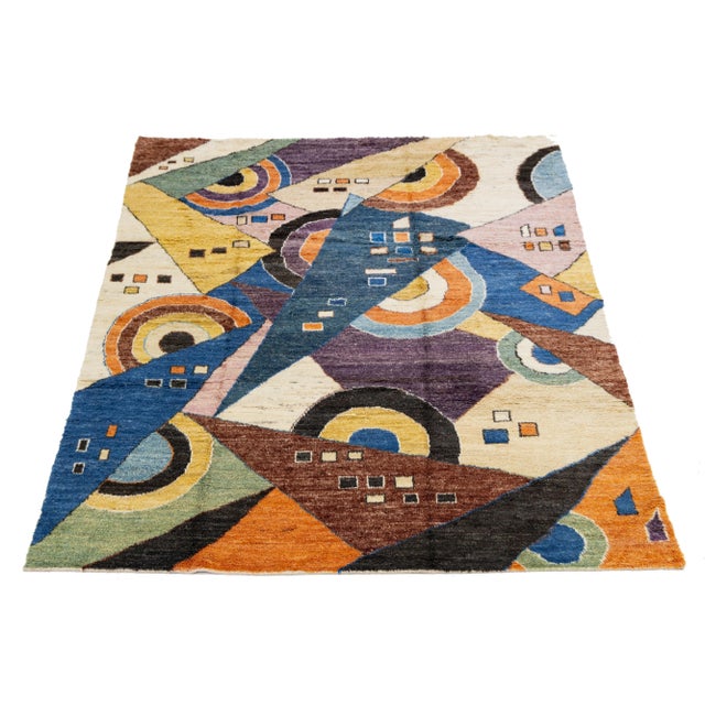 This beautifully crafted wool rug showcases a contemporary Moroccan design with a multicolored backdrop. The modern...