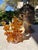 Striking vintage amber art glass sculpture featuring an elaborate arrangement of hand-formed floral and organic elements....