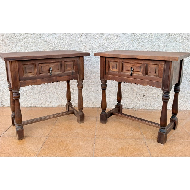Charming pair of Spanish bedside tables dating from the mid-20th century. Crafted in wood, each table features a single...