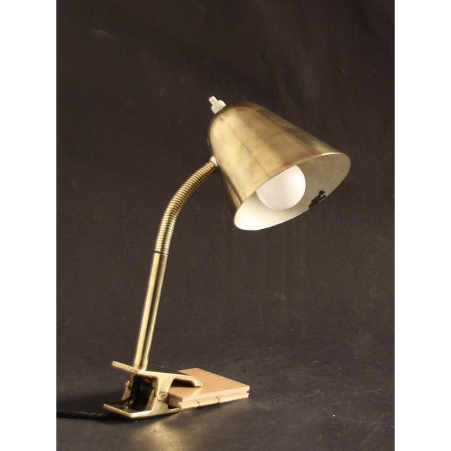 Very rare, unusual table lamp consisting of solid brass, which can be glued to the desk or on a shelf. The umbrella can be...