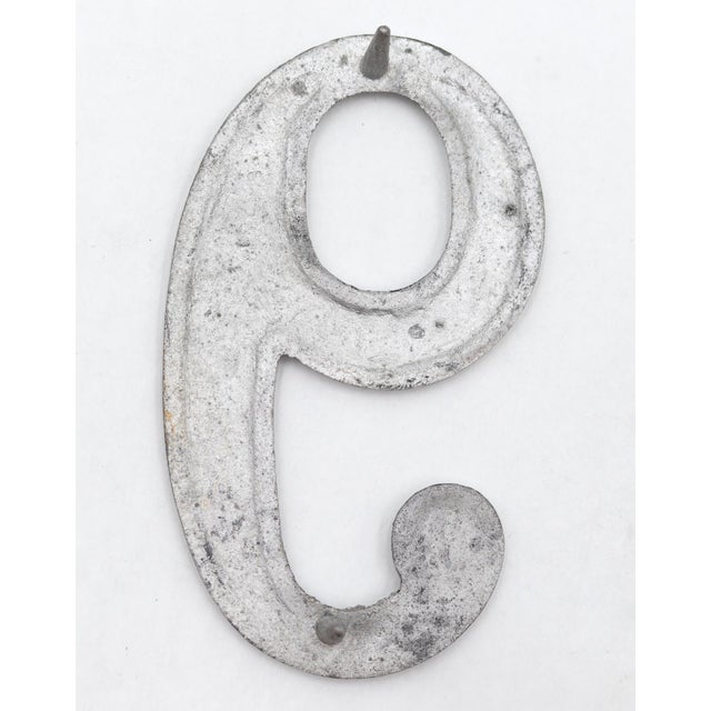 Vintage brushed aluminum numeral 9 outdoor house or building marker with two prongs on the back. Good condition with...