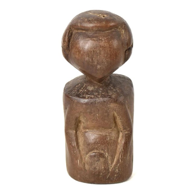 The Azande miniature figure was hand-carved by the Azande artisans of the Democratic Republic of the Congo, but the Azande...