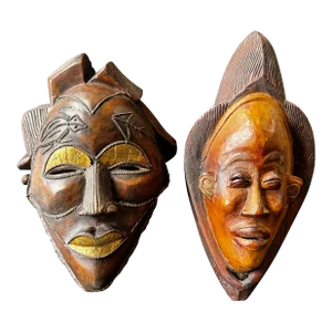 Two Carved Wood African Mask With Gilded Eyelids and Lips and Brass Decorations