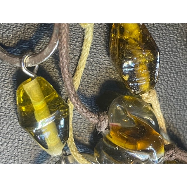 Individually handcrafted via high-temperature lampworking, a huge three strand each beaded necklace that features two-tone...