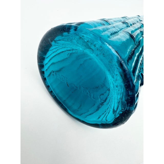 Vintage pair of blue glass decanters/genie bottles with stoppers. One is marked Made in Italy on the bottom. Good vintage...