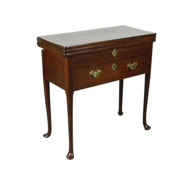 An 18th-C. American Queen Ann triple top mahogany game table with a tooled black leather playing surface, a single frieze...