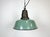 Industrial green enamel pendant light made in Poland during the 1960s. White enamel inside the shade. Cast iron top. The...