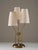This Swedish Art Deco table lamp is crafted in brass and features an elegant sculptural form. The base is adorned with a...