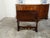 An Italian walnut hall bench from the 19th century, with carved back, voluted arms and stylized paw feet. Created in Italy...