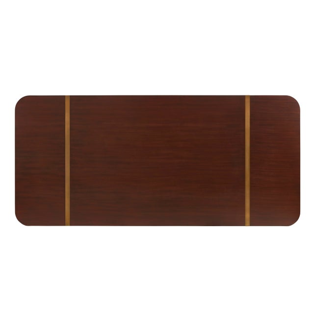 Contemporary mahogany dining table with geometric bases, finished in rich mahogany finish. Antique brass finished band...