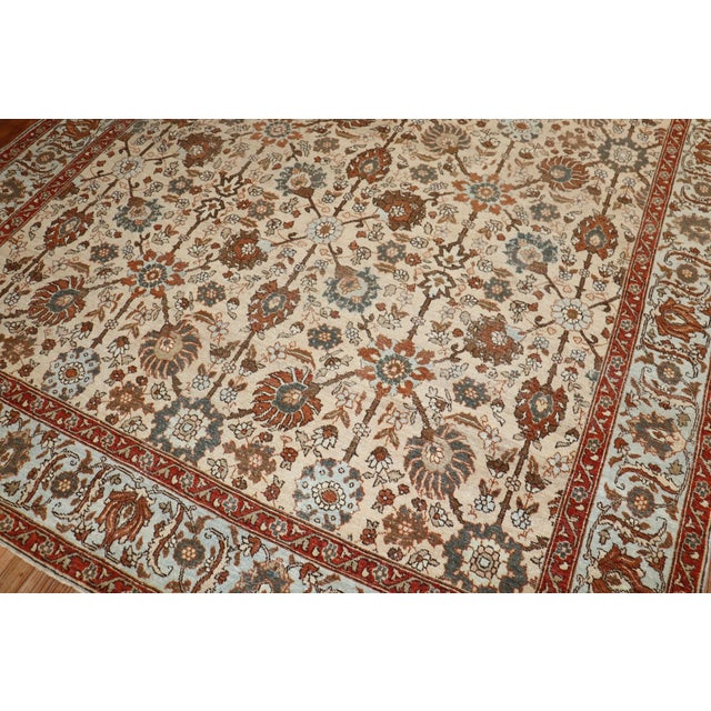 1920s Persian tabriz rug with an all over design with slate , brown and gray accents on a khaki color ground