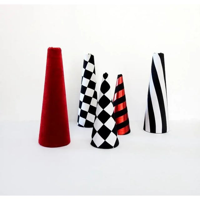 Amazing minimalist conical Christmas trees set in Memphis style. Black and white checkered, striped, solid red, and black...