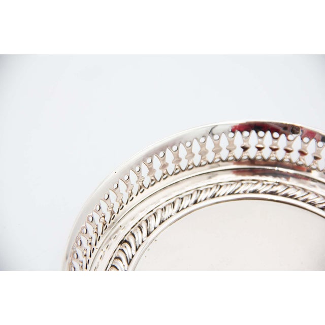 Plain Silver Circular Bottle Base with Wire Rack, in Very Good conditions. Designed 1920 to 1949 This piece has an...