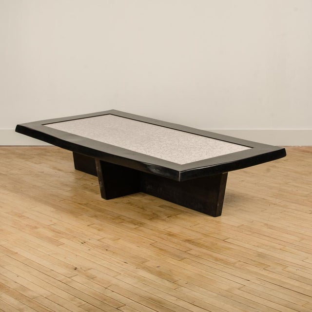 A Modernist rectangular coffee table with a unique surface of delicate eggshell fragments on a solid walnut base....